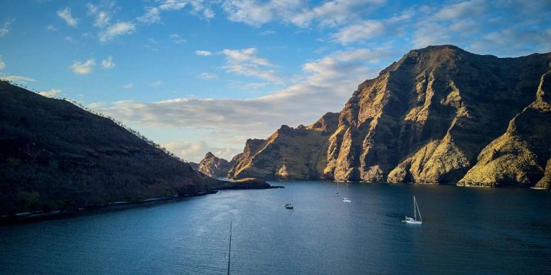 Voiliers au mouillage dans la baie d'Akatea, au pied des falaises de Nuku Hiva